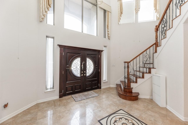 16206 Lobo Ln, Spring, TX 77379 - entrance foyer with healthy amount of natural light, a towering ceiling, stairway, and baseboards