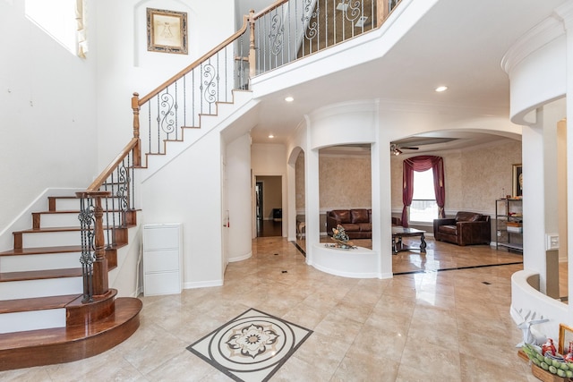16206 Lobo Ln, Spring, TX 77379 - entrance foyer featuring arched walkways, a ceiling fan, crown molding, stairs, and recessed lighting