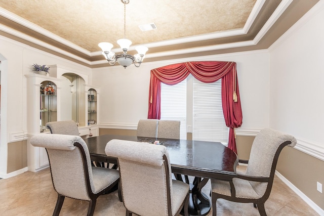 16206 Lobo Ln, Spring, TX 77379 - dining area featuring a chandelier, crown molding, a raised ceiling, arched walkways, and light tile patterned floors