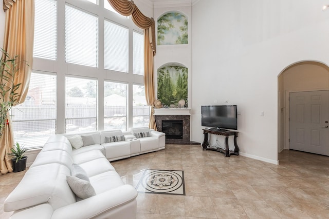 16206 Lobo Ln, Spring, TX 77379 - living room with a high ceiling, plenty of natural light, arched walkways, a premium fireplace, and baseboards