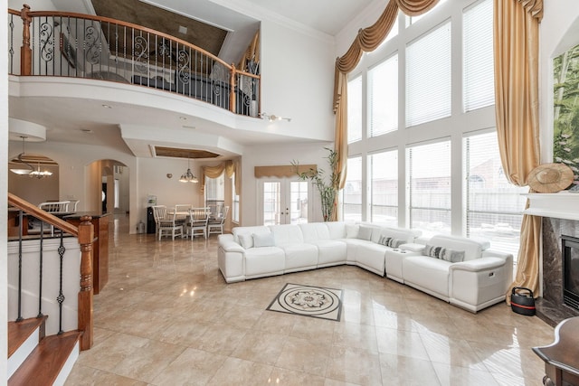 16206 Lobo Ln, Spring, TX 77379 - living area with stairway, arched walkways, a high end fireplace, ornamental molding, and a towering ceiling