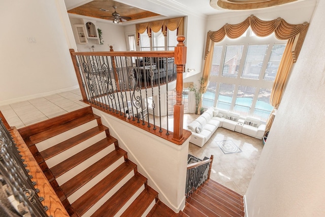 16206 Lobo Ln, Spring, TX 77379 - staircase featuring healthy amount of natural light, tile patterned flooring, a ceiling fan, and crown molding