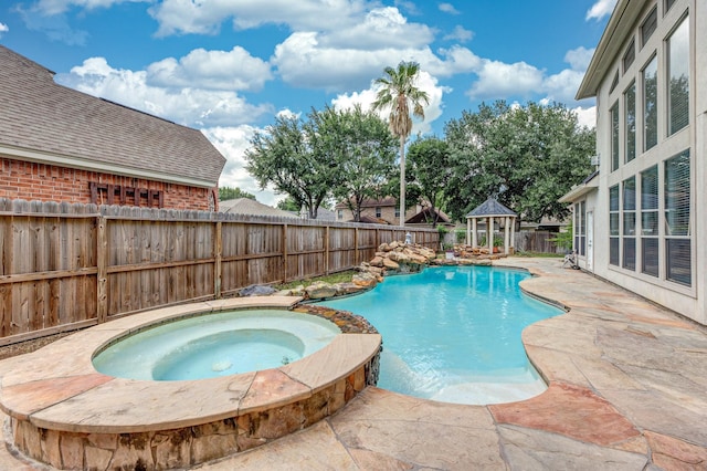 16206 Lobo Ln, Spring, TX 77379 - view of swimming pool featuring a gazebo, a fenced backyard, a pool with connected hot tub, and a patio