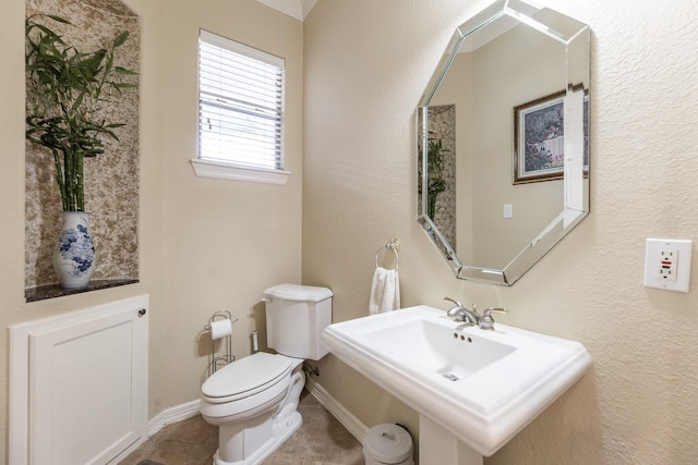 16206 Lobo Ln, Spring, TX 77379 - half bathroom featuring toilet, a sink, baseboards, tile patterned floors, and a textured wall