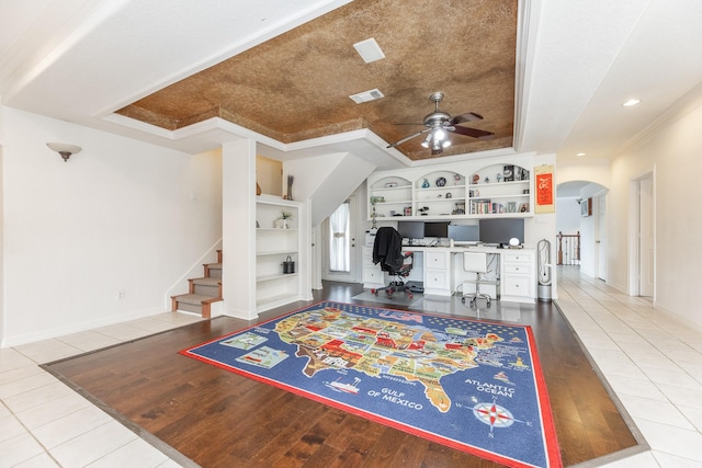 16206 Lobo Ln, Spring, TX 77379 - office with a ceiling fan, built in desk, built in shelves, arched walkways, and crown molding
