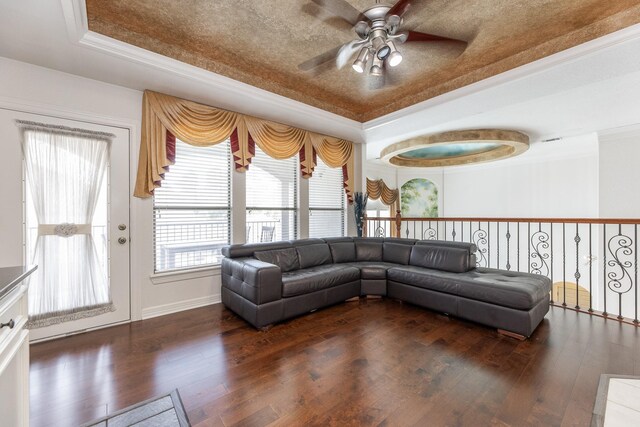 16206 Lobo Ln, Spring, TX 77379 - living room featuring a tray ceiling, ceiling fan, wood-type flooring, ornamental molding, and baseboards