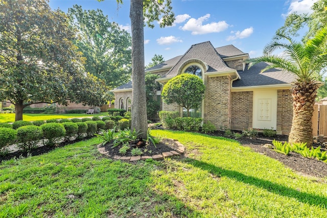 3407 Gold Candle Dr, Spring, TX 77388 - view of front facade featuring brick siding, a front yard, and a shingled roof