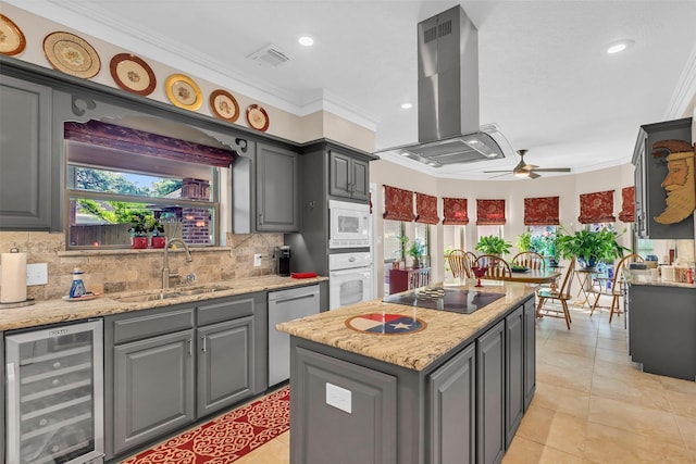 3407 Gold Candle Dr, Spring, TX 77388 - kitchen featuring beverage cooler, island range hood, a sink, white appliances, and gray cabinets