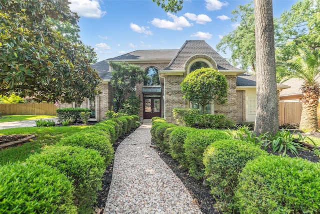 3407 Gold Candle Dr, Spring, TX 77388 - french provincial home featuring brick siding, french doors, and roof with shingles