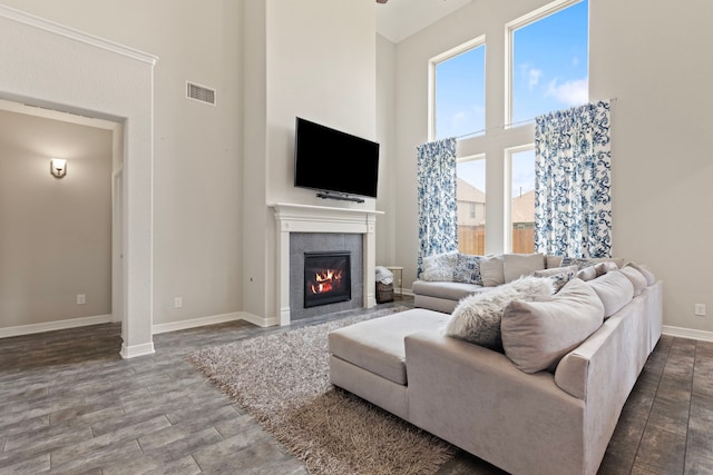 9414 Peralta Creek Ct, Cypress, TX 77433 - living area featuring a high ceiling, a fireplace, plenty of natural light, wood finished floors, and baseboards