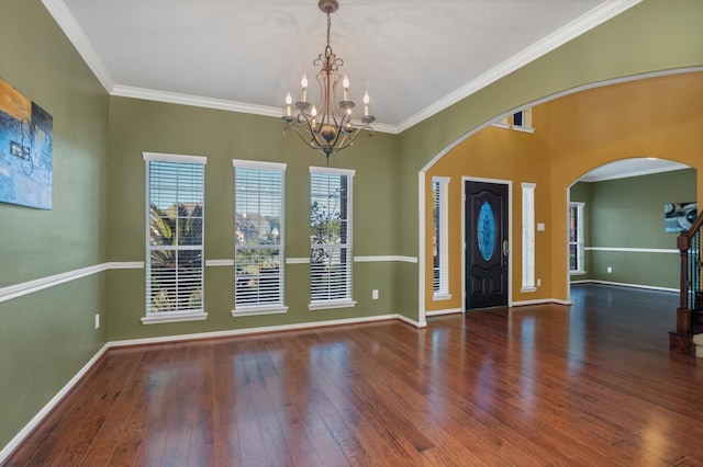 2402 Leslie Ln, Deer Park, TX 77536 - entrance foyer featuring a chandelier, arched walkways, hardwood / wood-style floors, crown molding, and baseboards