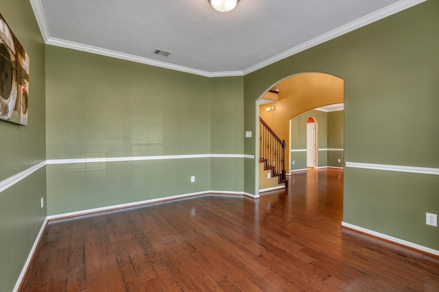 2402 Leslie Ln, Deer Park, TX 77536 - empty room featuring hardwood / wood-style floors, baseboards, ornamental molding, arched walkways, and stairs