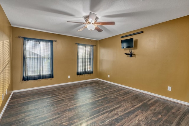 2402 Leslie Ln, Deer Park, TX 77536 - spare room featuring a ceiling fan, wood finished floors, and baseboards