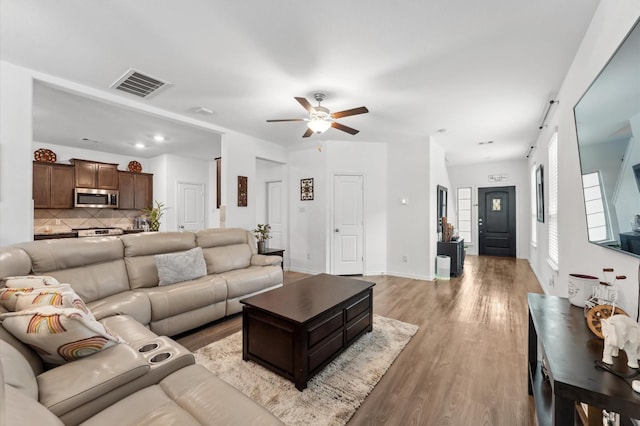 19018 Cicerone Ct, New Caney, TX 77357 - living room with a ceiling fan and light wood-style floors