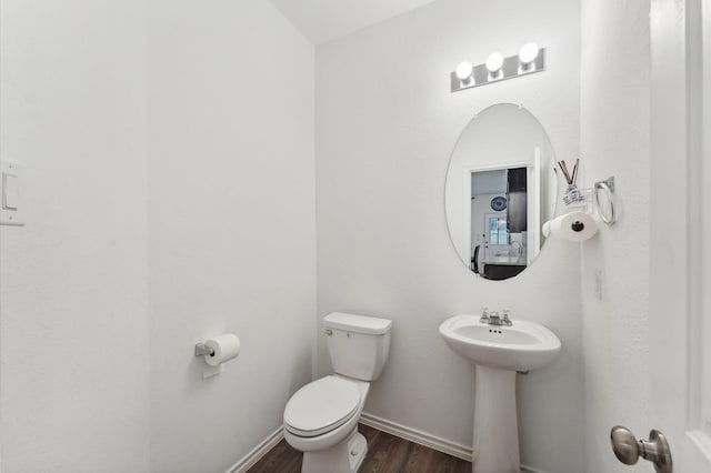19018 Cicerone Ct, New Caney, TX 77357 - bathroom with wood finished floors, toilet, baseboards, and a sink