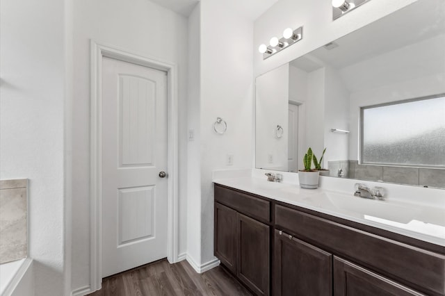 19018 Cicerone Ct, New Caney, TX 77357 - bathroom featuring double vanity and wood finished floors