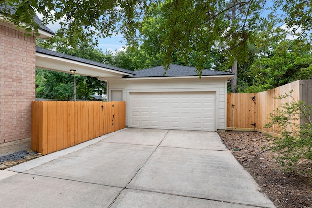 51 N Frosted Pond Dr, The Woodlands, TX 77381 - garage with concrete driveway and a gate