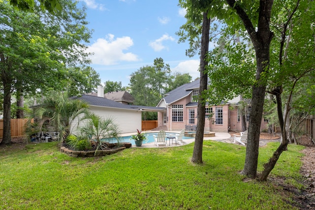 51 N Frosted Pond Dr, The Woodlands, TX 77381 - rear view of property featuring an outdoor pool, brick siding, and a patio