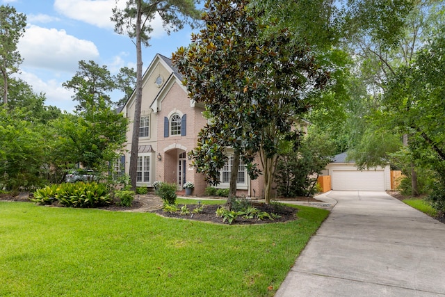 51 N Frosted Pond Dr, The Woodlands, TX 77381 - view of front of house with brick siding, a front yard, and concrete driveway
