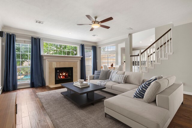 51 N Frosted Pond Dr, The Woodlands, TX 77381 - living room featuring crown molding, a fireplace, a ceiling fan, hardwood / wood-style floors, and stairs