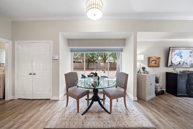 14211 Manderly Dr, Houston, TX 77077 - dining area with light wood finished floors, ornamental molding, baseboards, and washer / dryer