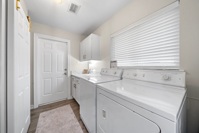 14211 Manderly Dr, Houston, TX 77077 - washroom featuring independent washer and dryer, cabinet space, and dark wood-type flooring