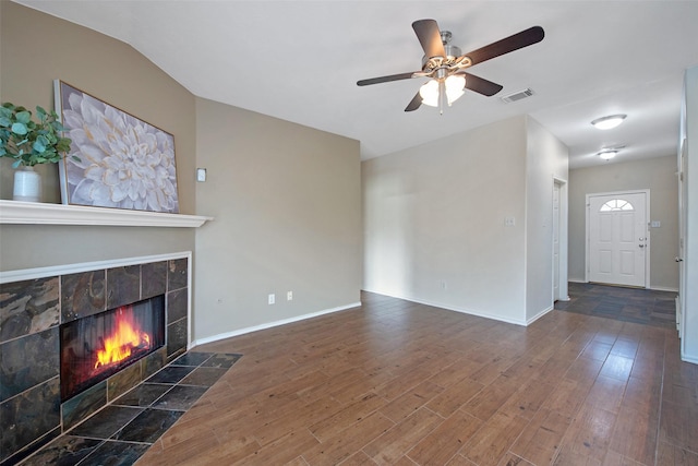 16315 Redbud Berry Ln, Cypress, TX 77433 - unfurnished living room with a tile fireplace, a ceiling fan, wood finished floors, baseboards, and lofted ceiling
