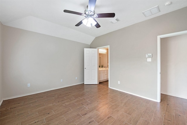 16315 Redbud Berry Ln, Cypress, TX 77433 - unfurnished bedroom with wood finished floors, lofted ceiling, ensuite bath, baseboards, and a ceiling fan