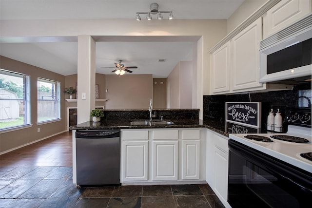 16315 Redbud Berry Ln, Cypress, TX 77433 - kitchen with stainless steel dishwasher, electric stove, white microwave, a sink, and decorative backsplash