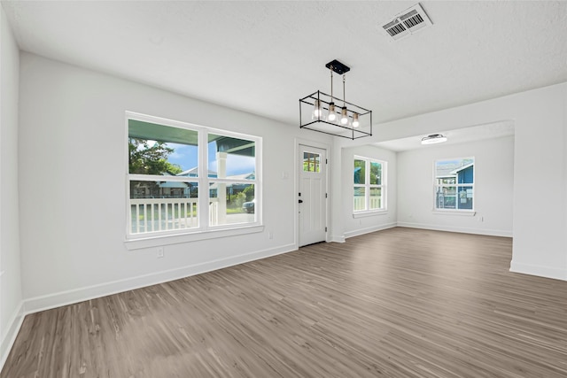 3910 Cetti St, Houston, TX 77009 - entryway with wood finished floors, baseboards, and a chandelier