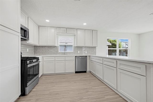 3910 Cetti St, Houston, TX 77009 - kitchen with stainless steel appliances, light countertops, backsplash, and recessed lighting
