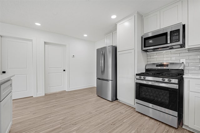 3910 Cetti St, Houston, TX 77009 - kitchen featuring appliances with stainless steel finishes, light wood-style flooring, backsplash, light countertops, and recessed lighting