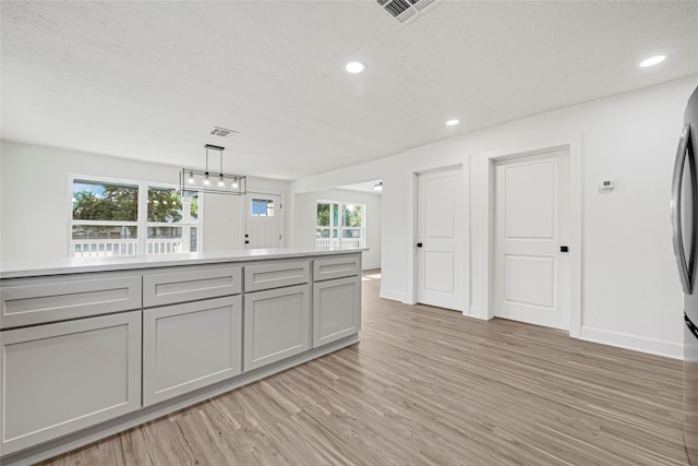3910 Cetti St, Houston, TX 77009 - kitchen featuring light wood-style floors, gray cabinetry, light countertops, recessed lighting, and baseboards