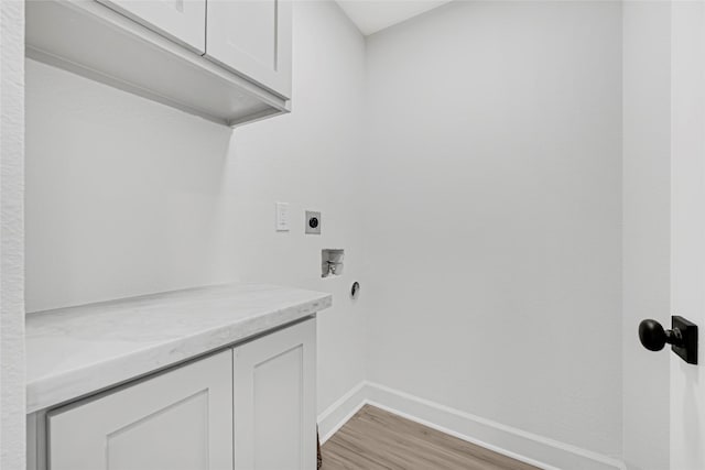 3910 Cetti St, Houston, TX 77009 - washroom with electric dryer hookup, cabinet space, baseboards, light wood-style flooring, and washer hookup