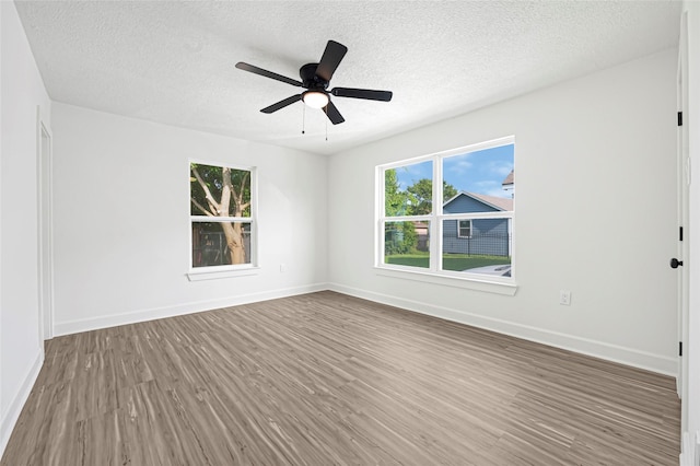 3910 Cetti St, Houston, TX 77009 - unfurnished room featuring wood finished floors, a textured ceiling, baseboards, and ceiling fan