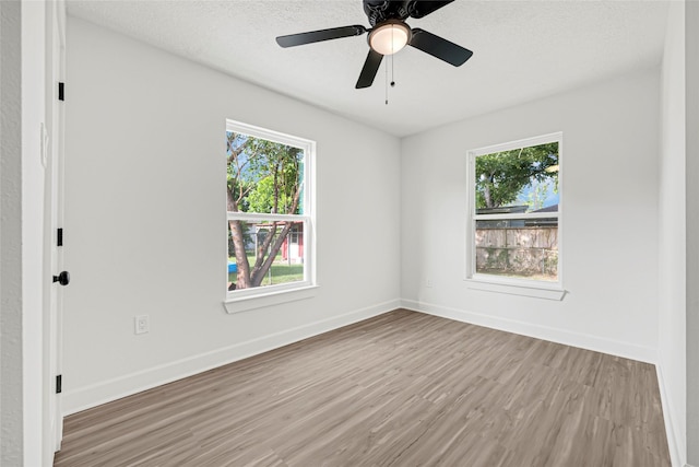 3910 Cetti St, Houston, TX 77009 - unfurnished room with wood finished floors, baseboards, and a textured ceiling