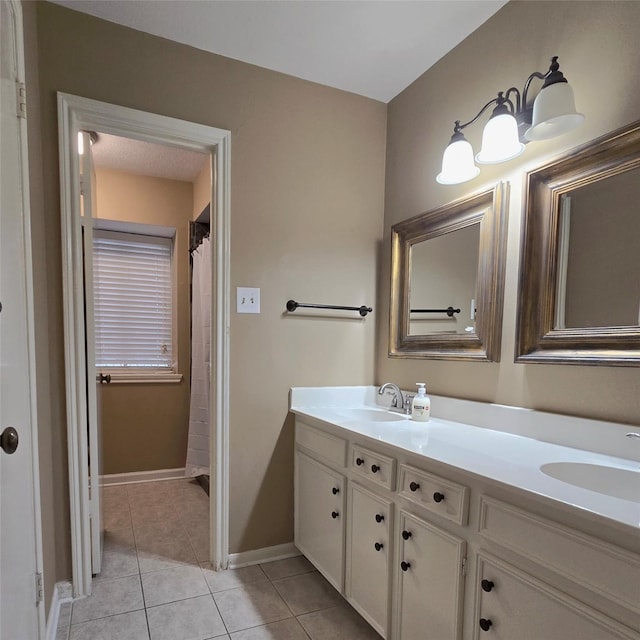20339 Acapulco Cove Dr, Humble, TX 77346 - bathroom with double vanity, tile patterned flooring, and baseboards