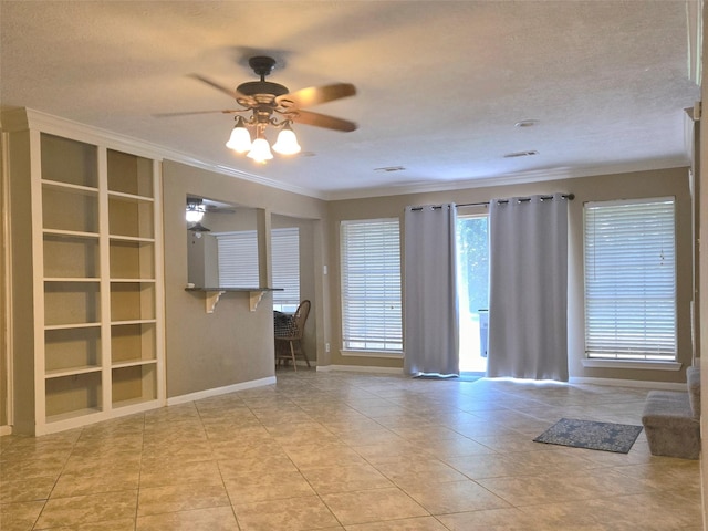 20339 Acapulco Cove Dr, Humble, TX 77346 - unfurnished living room featuring built in features, ornamental molding, a ceiling fan, light tile patterned flooring, and baseboards