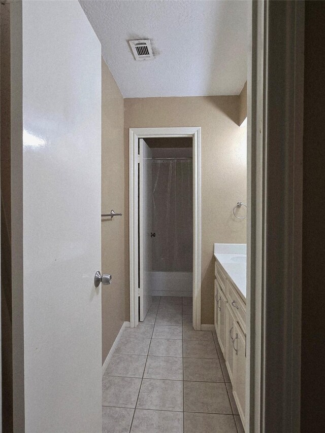 20339 Acapulco Cove Dr, Humble, TX 77346 - bathroom with vanity, a spacious closet, tile patterned flooring, and baseboards