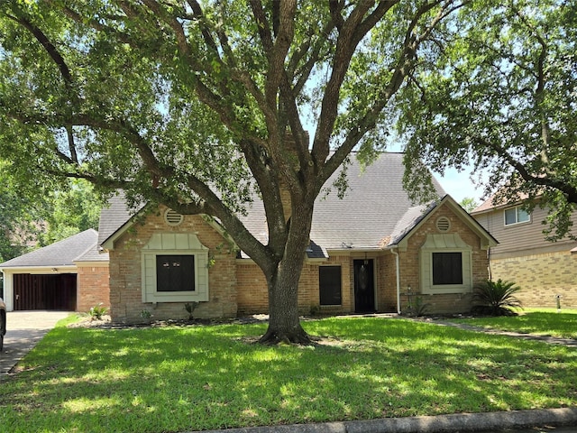 20339 Acapulco Cove Dr, Humble, TX 77346 - view of front of home featuring brick siding, a front lawn, a shingled roof, and an attached garage