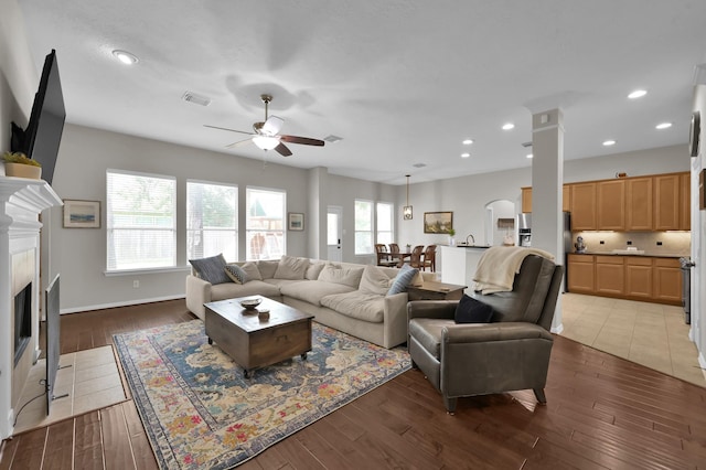 2103 Gaylin Hills Ct, Spring, TX 77386 - living room with ceiling fan, a fireplace, hardwood / wood-style flooring, recessed lighting, and decorative columns