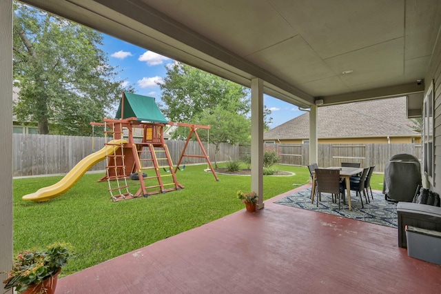 2103 Gaylin Hills Ct, Spring, TX 77386 - fenced backyard with a playground, outdoor dining area, a patio area, and grilling area
