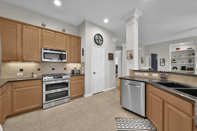 2103 Gaylin Hills Ct, Spring, TX 77386 - kitchen with appliances with stainless steel finishes, backsplash, dark countertops, ornate columns, and light tile patterned flooring