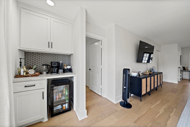 1902 Knoboak Cir, Houston, TX 77080 - indoor bar featuring beverage cooler, light wood finished floors, tasteful backsplash, baseboards, and recessed lighting