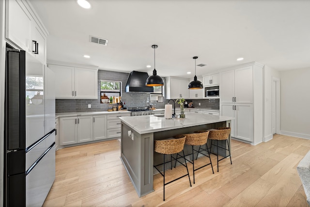1902 Knoboak Cir, Houston, TX 77080 - kitchen with high end refrigerator, extractor fan, a sink, stainless steel microwave, and backsplash