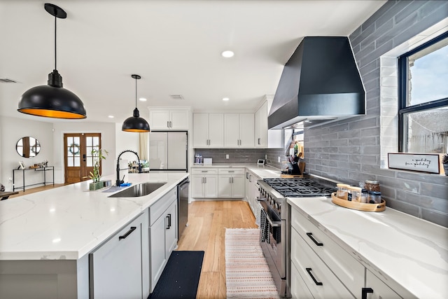 1902 Knoboak Cir, Houston, TX 77080 - kitchen with wall chimney exhaust hood, stainless steel appliances, a sink, backsplash, and recessed lighting