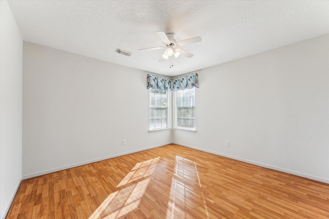13822 Inland Spring Ct, Houston, TX 77059 - spare room with light wood-style floors, a ceiling fan, baseboards, and a textured ceiling