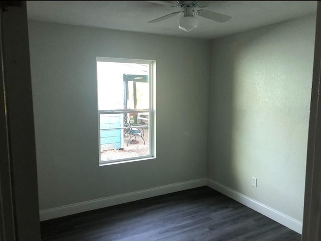 5223 Windemere St, Houston, TX 77033 - spare room featuring baseboards, dark wood finished floors, and ceiling fan