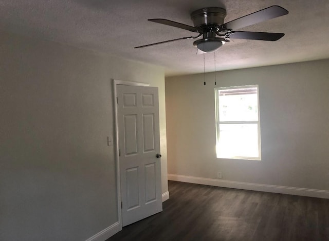 5223 Windemere St, Houston, TX 77033 - empty room with dark wood-style floors, baseboards, a ceiling fan, and a textured ceiling