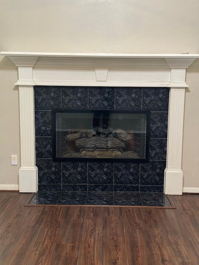 2232 Stableridge Dr, Conroe, TX 77384 - detailed view of a tile fireplace, wood finished floors, and baseboards